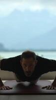 A Focused Man is Passionately Exercising with Pushups in a Beautiful Scenic Indoor Setting video