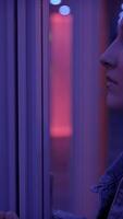 A Pensive Woman Enveloped in a Vibrant Neon Light Environment Creating a Unique Aesthetic video