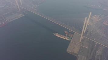 Drone view of the Golden Bridge and the city at dawn in heavy smog video