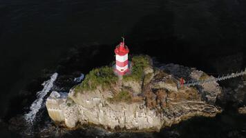 Drone view of the picturesque old Basargin lighthouse on the coast of the sea video