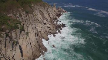 View from a droneon a stone cape washed by strong waves video