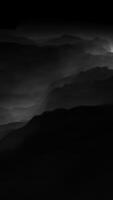 An enigmatic monochromatic landscape draped in a gentle, enchanting fog envelops the scene video