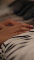 A warm hand gently resting on a soft fabric surface, invoking feelings of comfort and peace video