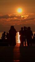 Silhouetted figures framed against a breathtaking sunset, creating a stunning view video