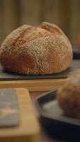 Artisan Sourdough Bread with a Delightfully Crusty Texture on a Rustic Wooden Table surface video