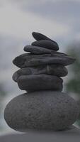 A Carefully Arranged Stack of Smooth Stones Sitting Gracefully on a Tranquil Background video