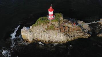 Drone view of the picturesque old Basargin lighthouse on the coast of the sea video