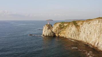 Drone view of the picturesque old Basargin lighthouse on the coast of the sea video