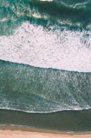 seashore on a beach, the waves are foaming. Background for maritime themes concept photo