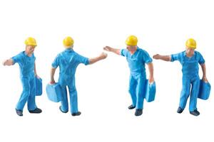 Miniature construction worker in a blue uniform isolate on white background with clipping path photo