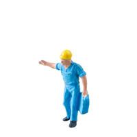 Miniature construction worker in a blue uniform isolate on white background with clipping path photo