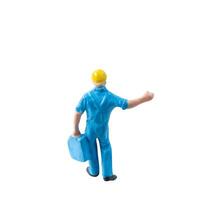 Miniature construction worker in a blue uniform isolate on white background with clipping path photo