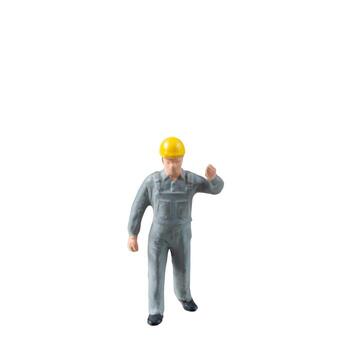 Miniature construction worker dressed in a jumpsuit isolate on white background with clipping path jumpsuit isolate on white background with clipping path photo