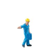Miniature construction worker in a blue uniform isolate on white background with clipping path photo