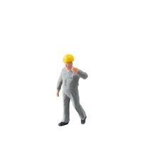 Miniature construction worker dressed in a jumpsuit isolate on white background with clipping path jumpsuit isolate on white background with clipping path photo