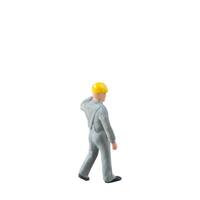 Miniature construction worker dressed in a jumpsuit isolate on white background with clipping path jumpsuit isolate on white background with clipping path photo