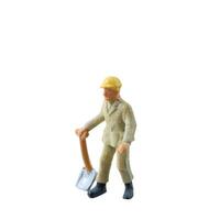 Miniature construction worker holding a shovel, isolate on white background with clipping path photo