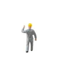 Miniature construction worker dressed in a jumpsuit isolate on white background with clipping path jumpsuit isolate on white background with clipping path photo