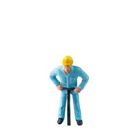Miniature construction worker in a blue uniform isolate on white background with clipping path photo