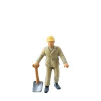 Miniature construction worker holding a shovel, isolate on white background with clipping path photo