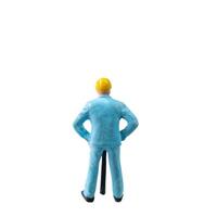 Miniature construction worker in a blue uniform isolate on white background with clipping path photo