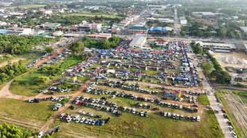 An aerial view of a large parking lot with lots of cars photo