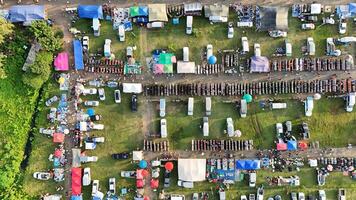 An aerial view of a large lot of tents and cars photo