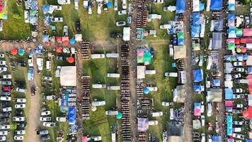 An aerial view of a large number of tents and cars photo