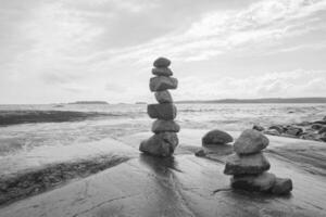 Stacked Rocks balancing, stacking with precision. Stone tower on the shore. Copy space photo