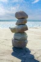 Stacked Rocks balancing, stacking with precision. Stone tower on the shore. Copy space photo