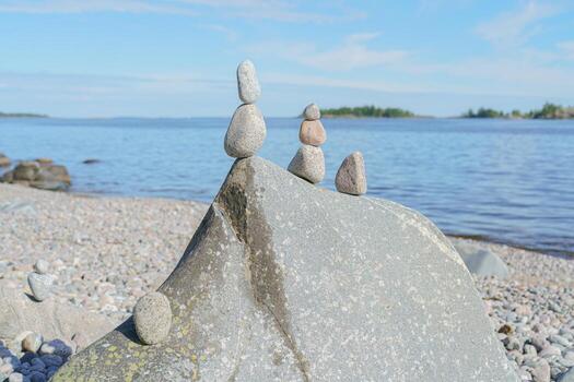 Stacked Rocks balancing, stacking with precision. Stone tower on the shore. Copy space photo