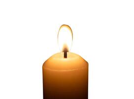 A single burning candle flame or light glowing on a big white candle isolated on white background with clipping path photo