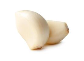 Side view of peeled garlic cloves in stack isolated on white background with clipping path photo