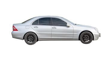 Side view of silver sedan car isolated on white background with clipping path photo