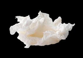 Side view of screwed or crumpled white tissue paper ball isolated on black background with clipping path photo