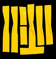 Top view set of wrinkled or crumpled yellow adhesive vinyl tape or cloth tape in stripes shape isolated on black background with clipping path photo