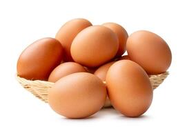 Group of fresh brown chicken eggs in stack in wicker basket isolated on white background with clipping path photo