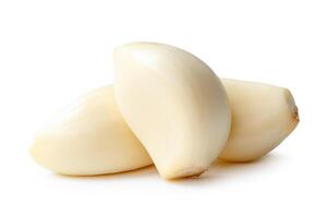 Side view of peeled garlic cloves in stack isolated on white background with clipping path photo
