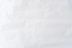 Top view and full frame of wrinkled or crumpled white stencil paper texture used for wrinkled or crumpled white paper background texture in decorative art work photo