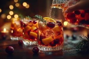 Pouring a Festive Christmas Sangria with Vibrant Fruit, Cranberries, and Rosemary Garnish photo