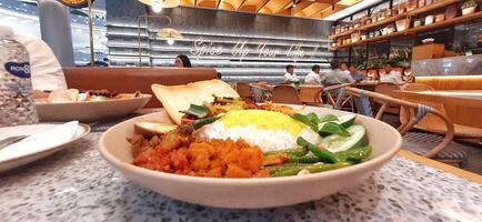 Delicious Nasi langgi menu made in Rempah Bistro restaurant located on shopping mall. Makassar, South Sulawesi, Indonesia - August 27 2024 photo