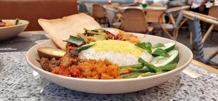 Delicious Nasi langgi menu made in Rempah Bistro restaurant located on shopping mall. Makassar, South Sulawesi, Indonesia - August 27 2024 photo