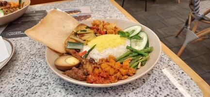 Delicious Nasi langgi menu made in Rempah Bistro restaurant located on shopping mall. Makassar, South Sulawesi, Indonesia - August 27 2024 photo
