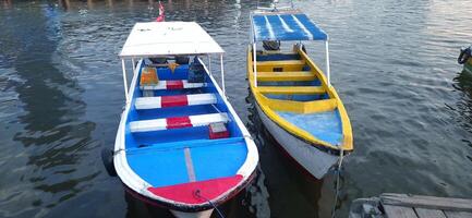 View of beauty sky jetty pannyua at Makassar Indonesia. Boats parked in docked afternoon photo