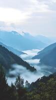 Misty Mountain Landscape at Dawn with Soft Layers and Gentle Fog photo