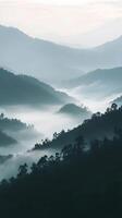 Misty Mountain Landscape at Dawn with Soft Layers and Gentle Fog photo