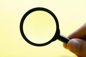 Hand holding magnifying with customizable space for text or ideas photo