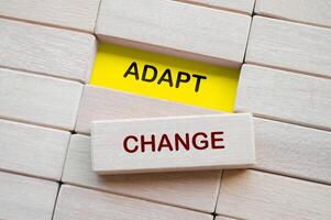 Top view of Adapt Change text on wooden blocks. Business adaption concept photo