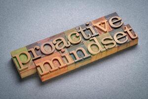 proactive mindset, approach to life characterized by taking initiative, anticipating challenges, and acting in advance to prevent problems, text in wood type photo