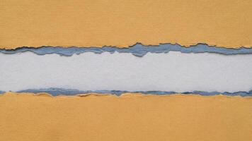 paper abstract in orange and blue tones with a copy space - sheets of handmade paper, blank web banner photo